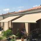 Store banne sur mesure Storbox300 Ivoire sur une maison plein pied